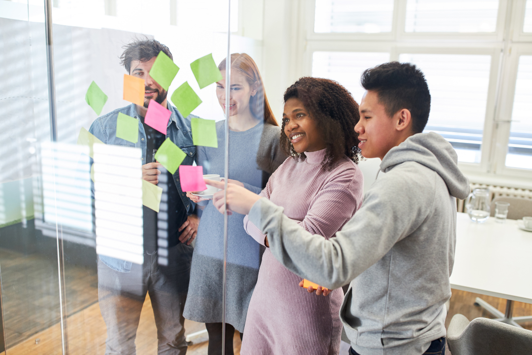 Small team brainstorming viral marketing ideas with sticky notes